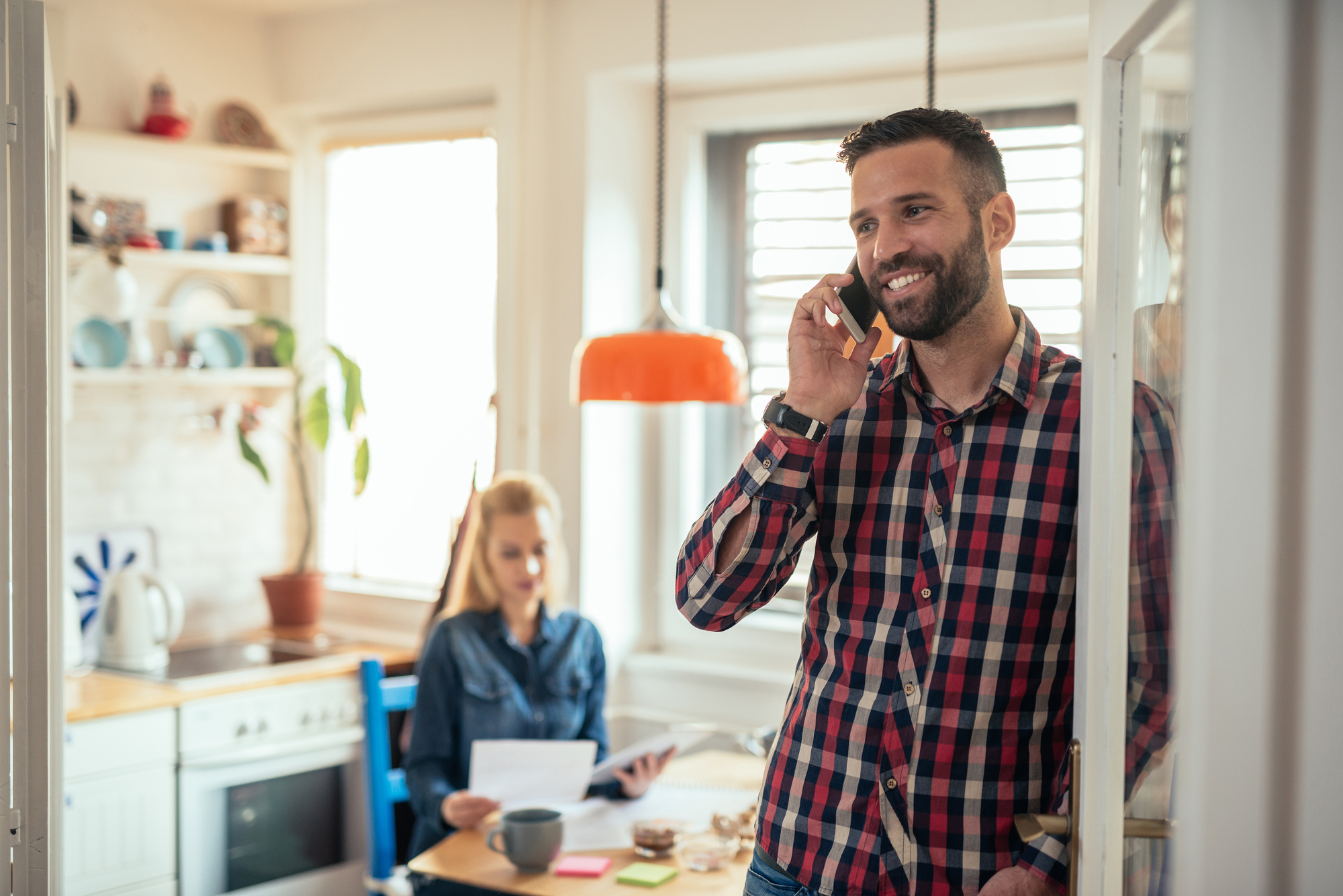 Man Talking on Phone in Kitchen.